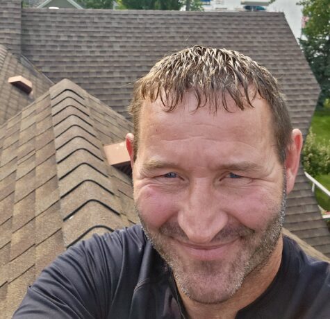 Allied Construction team member performing a roofing inspection on a Minnesota home.