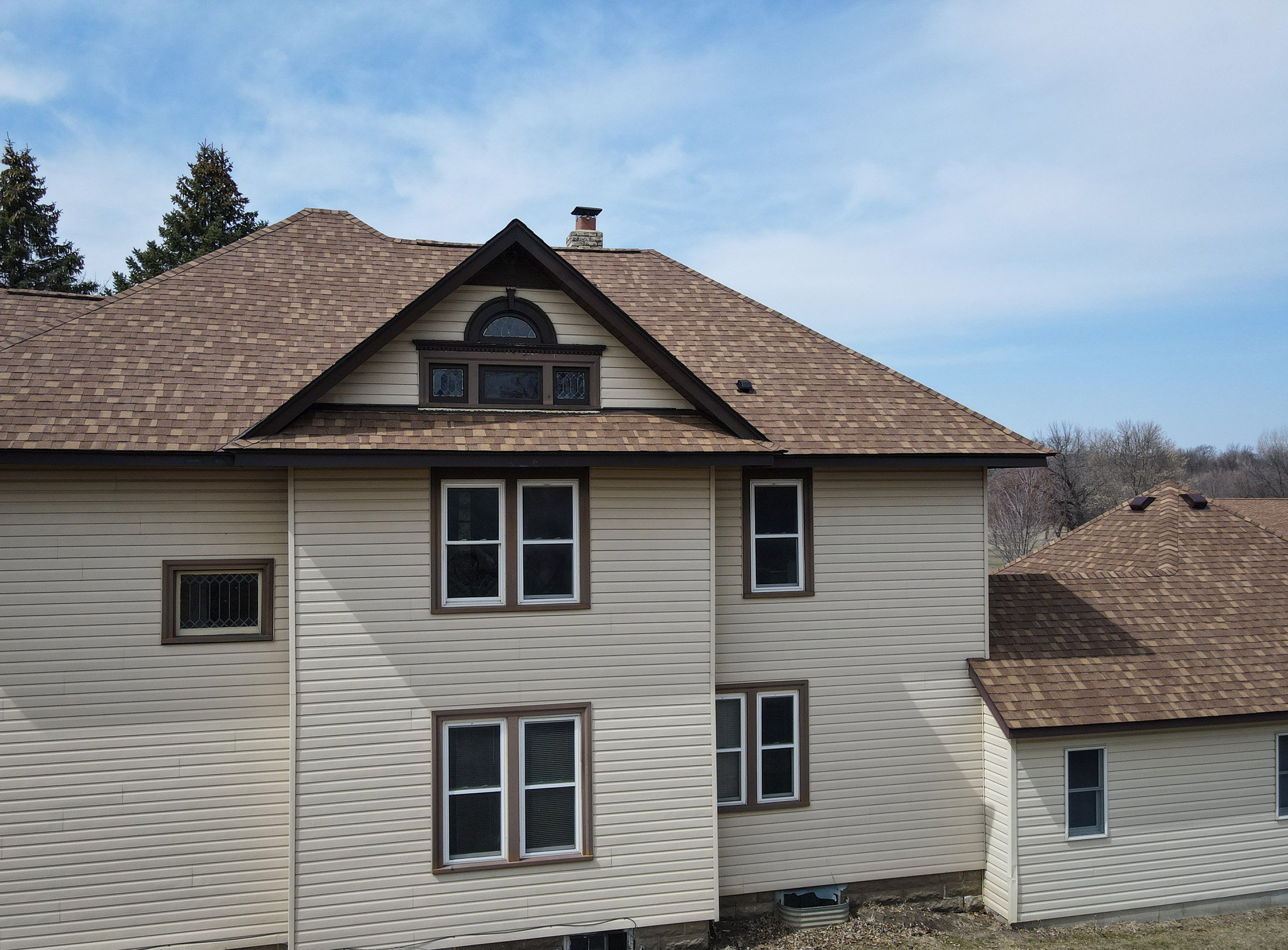 Close-up of upper story roofline and shingle detail