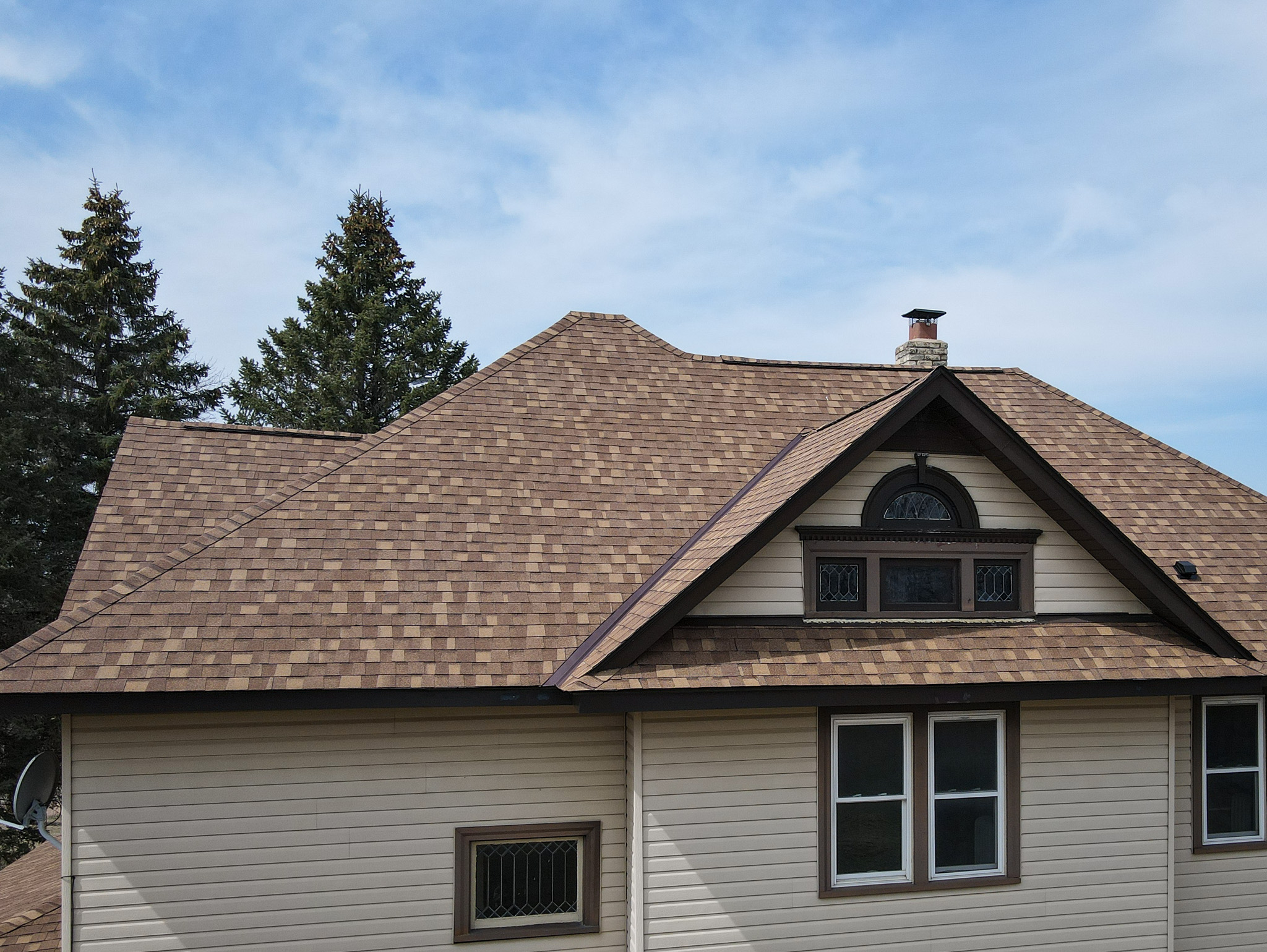 Finished roof with intricate dormer and custom shingle alignment