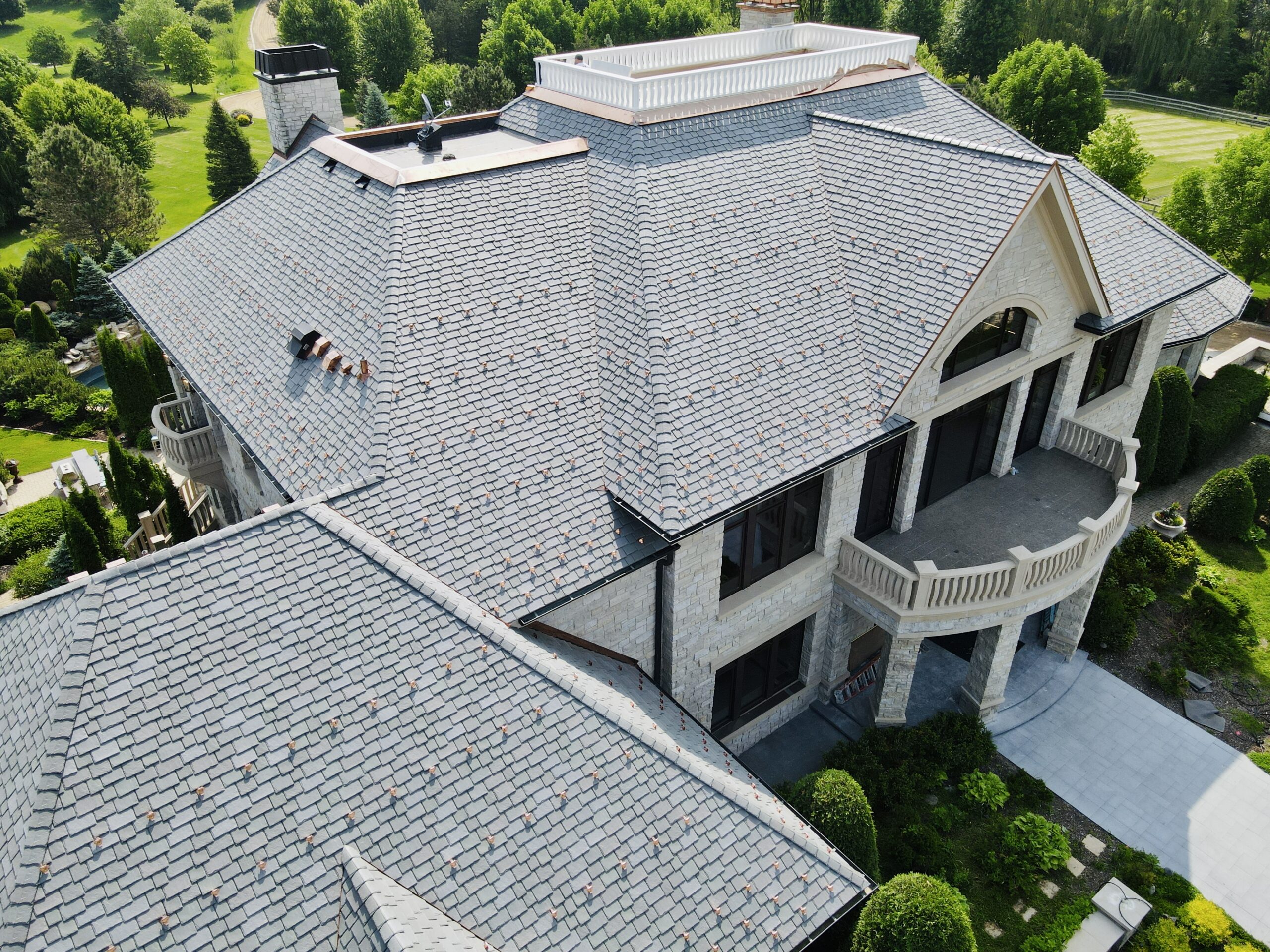 Elegant slate roofing installed on a luxury estate in Minnetrista, MN, featuring architectural details and premium craftsmanship.