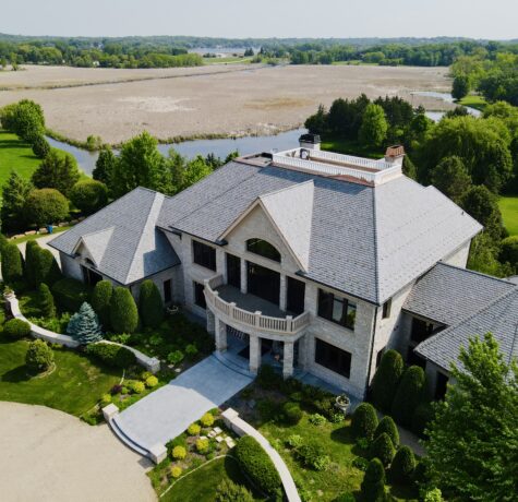 Stunning slate roof on a custom home in Minnetrista, MN, overlooking natural wetlands and lush greenery.