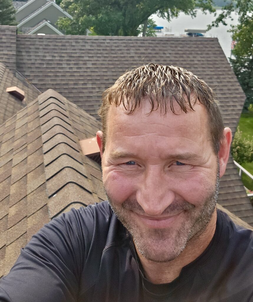 Allied Construction team member performing a roofing inspection on a Minnesota home.