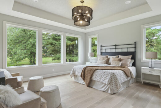 Bright bedroom with large windows and neutral tones