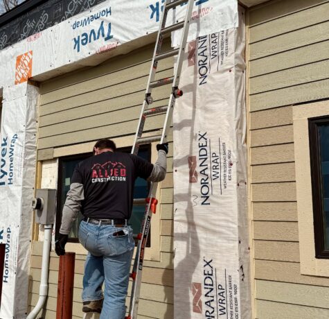 Allied Construction team member installing siding on Minnesota home
