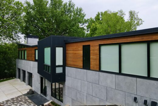 Angled side view of luxury modern home with flat roof