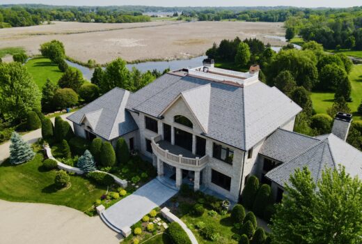 Stunning slate roof on a custom home in Minnetrista, MN, overlooking natural wetlands and lush greenery.