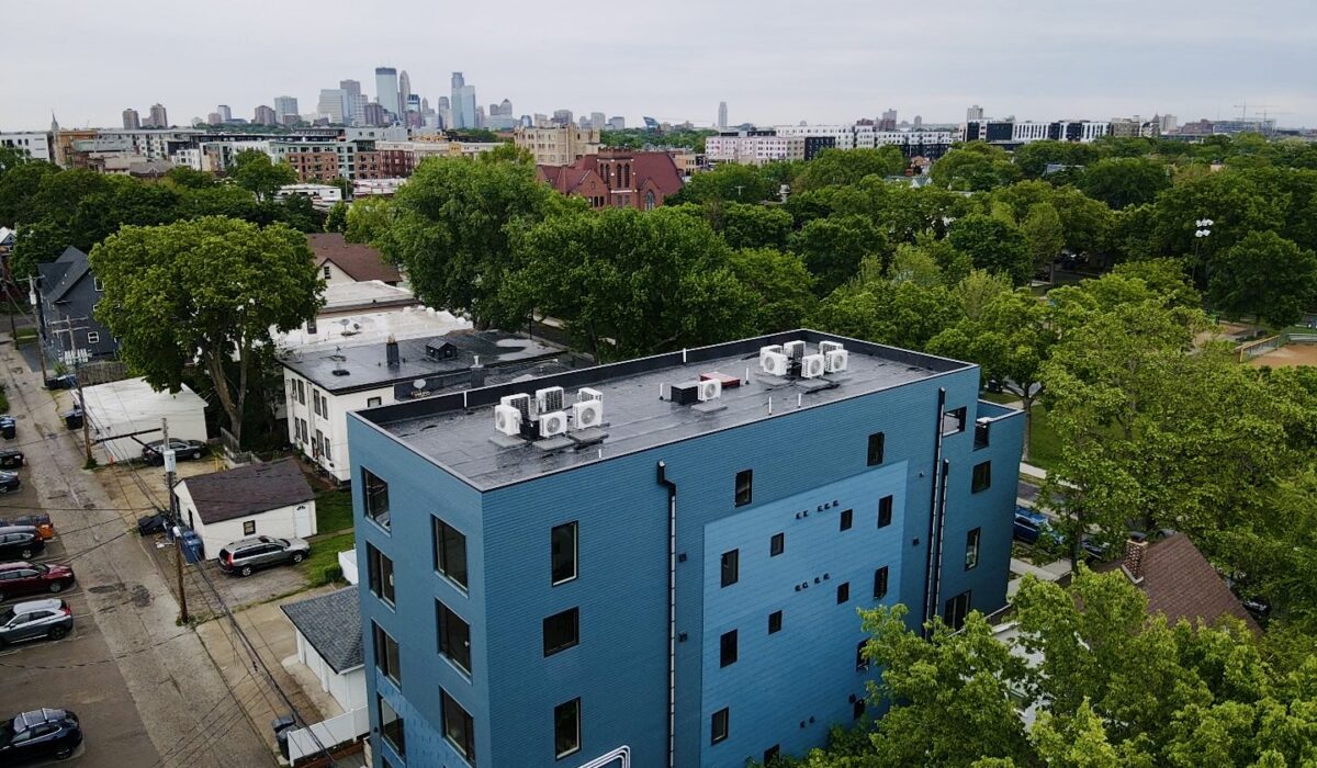 Overhead image of Bryant Ave Lofts with Minneapolis skyline in the background.