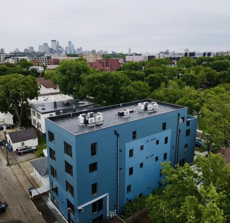 Overhead image of Bryant Ave Lofts with Minneapolis skyline in the background.