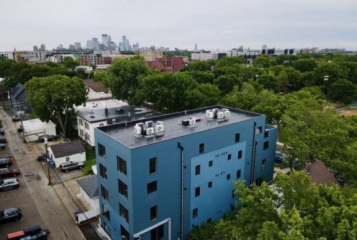 Overhead image of Bryant Ave Lofts with Minneapolis skyline in the background.