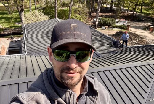 Allied Construction roofer standing on metal roof during installation