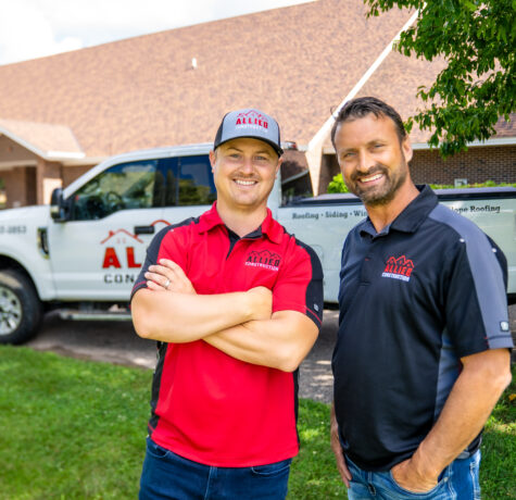 Adam and Eric, owners of Allied Construction, standing in front of branded company truck