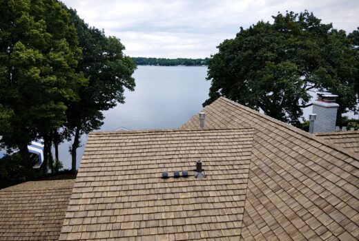 Roof view overlooking the lake with new Brava synthetic shake installation.