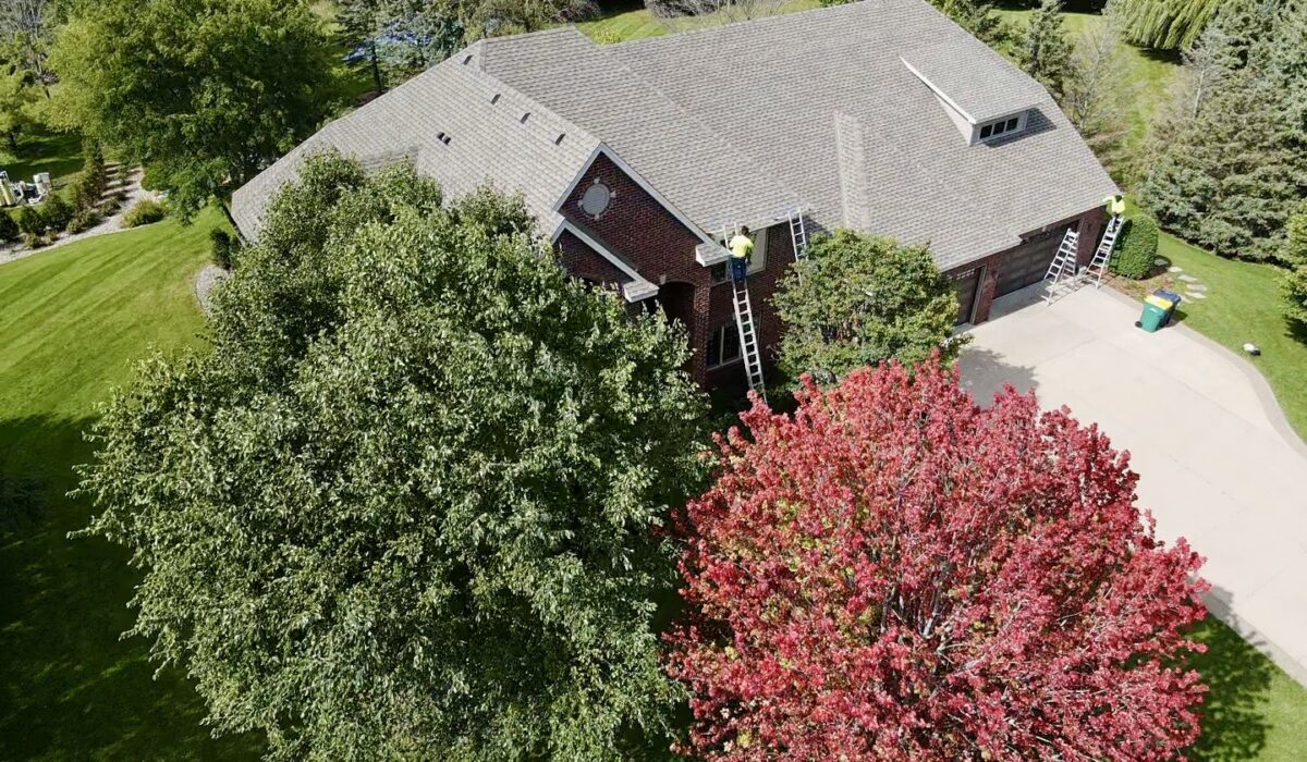 Aerial view of Maple Plain home with new roof, gutters, and fascia by Allied Construction.