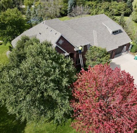 Aerial view of Maple Plain home with new roof, gutters, and fascia by Allied Construction.